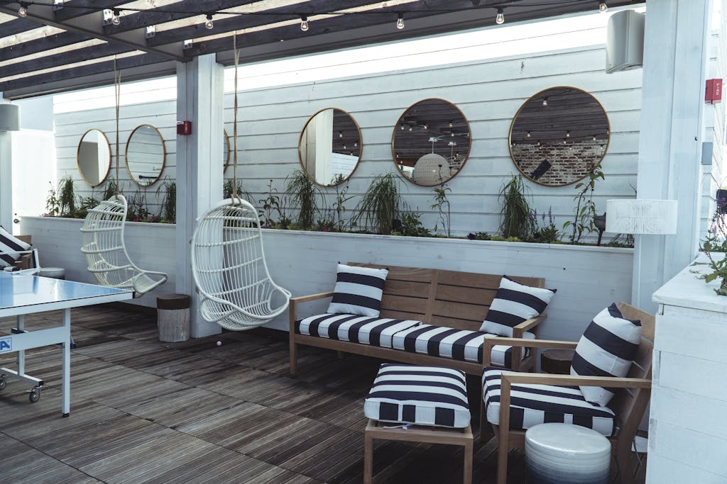 Interior with White Walls, Round Mirrors and Striped Cushions on Wooden Furniture